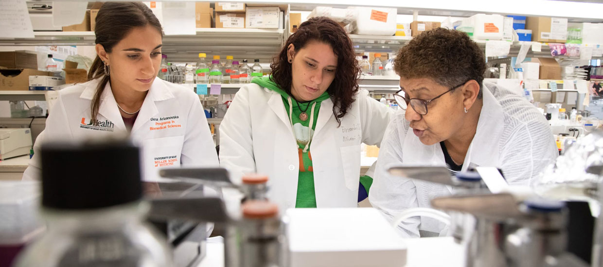 Students wearing lab coats in research lab