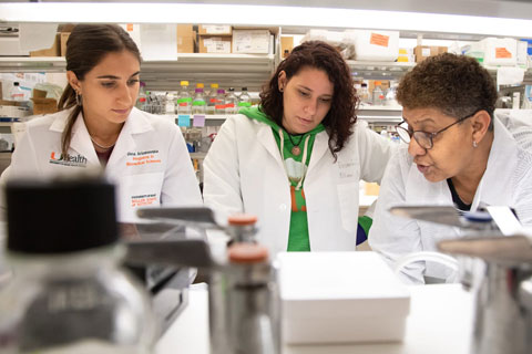 Students wearing lab coats in research lab