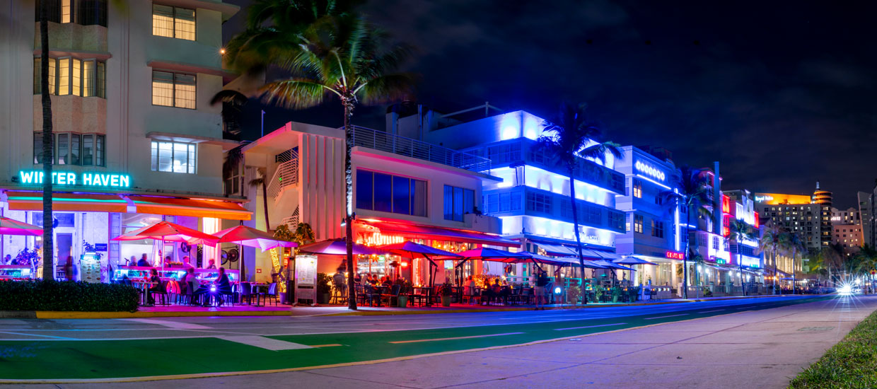 Night scene of lit buildings and street at Ocean Drive