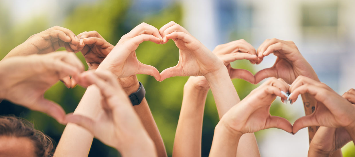 group of hands in the air making heart shapes