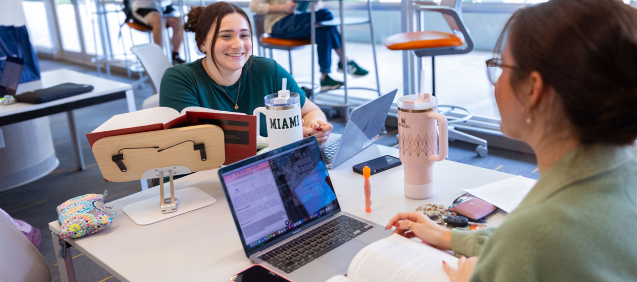 Students smiling on their computers
