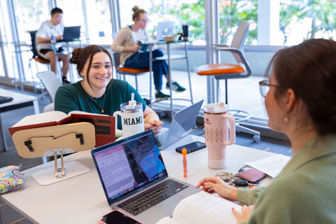 Students smiling on their computers