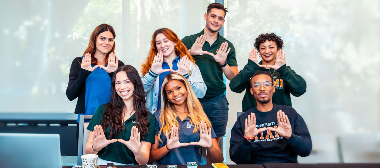 Group of students doing the "U" gesture